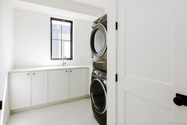 3530 Fenton St, Wheat Ridge, CO 80212 - laundry area featuring stacked washer / dryer and cabinet space