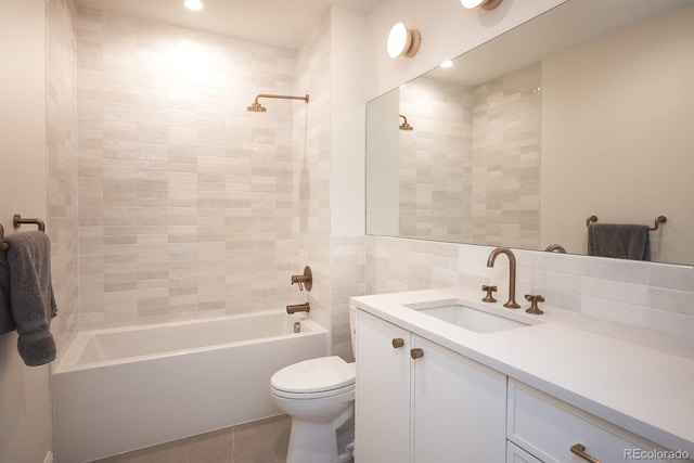 3530 Fenton St, Wheat Ridge, CO 80212 - bathroom featuring toilet,  shower combination, vanity, tile walls, and tile patterned flooring