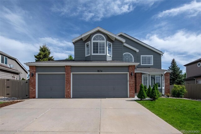 traditional-style home with brick siding, concrete driveway, and a garage