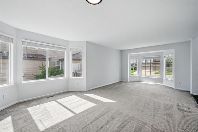 spare room with carpet floors and baseboards