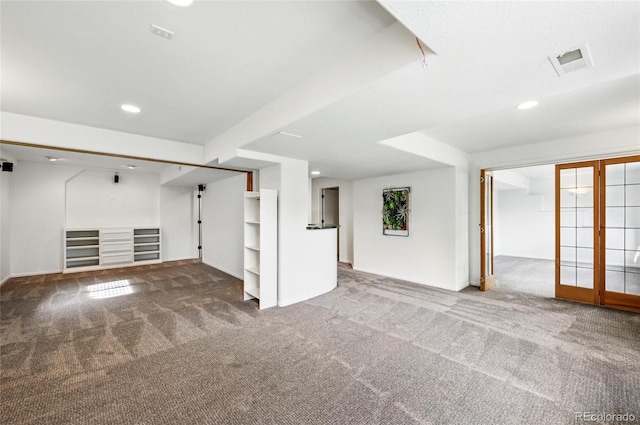 unfurnished living room with carpet, baseboards, and recessed lighting
