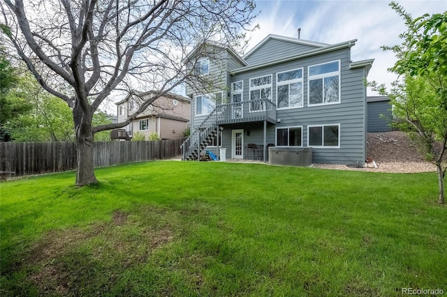 rear view of house featuring stairs and a wooden deck