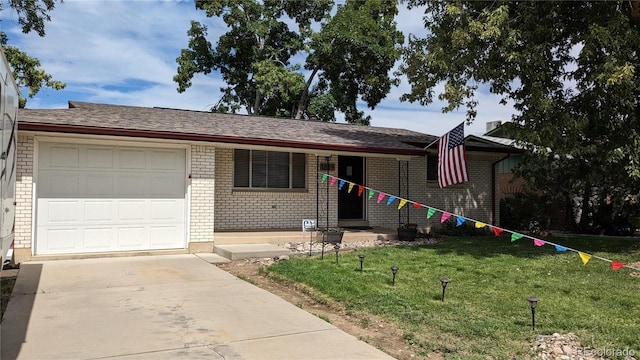 single story home featuring a garage and a front lawn