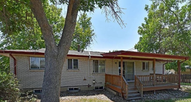 back of house with a wooden deck