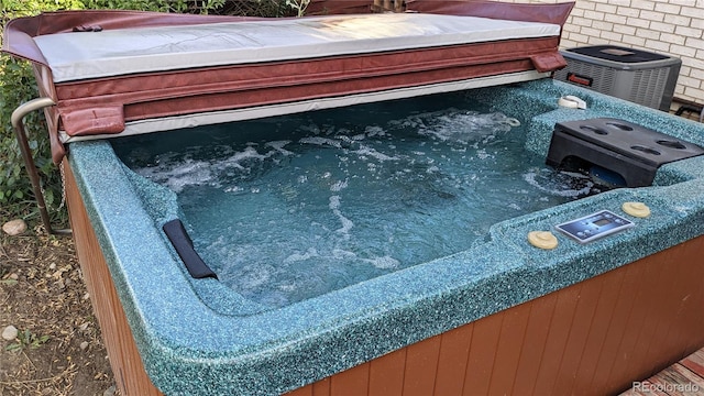 view of pool with a hot tub