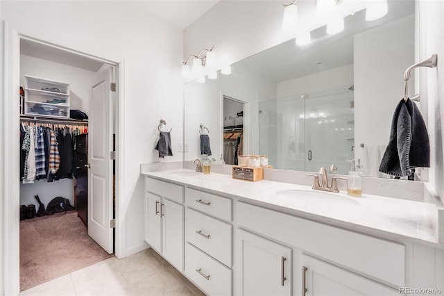 bathroom with vanity, an enclosed shower, and tile patterned flooring