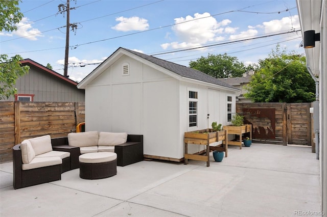 3478 Chase St, Wheat Ridge, CO 80212 - fenced backyard featuring a patio area, an outdoor hangout area, and an outbuilding