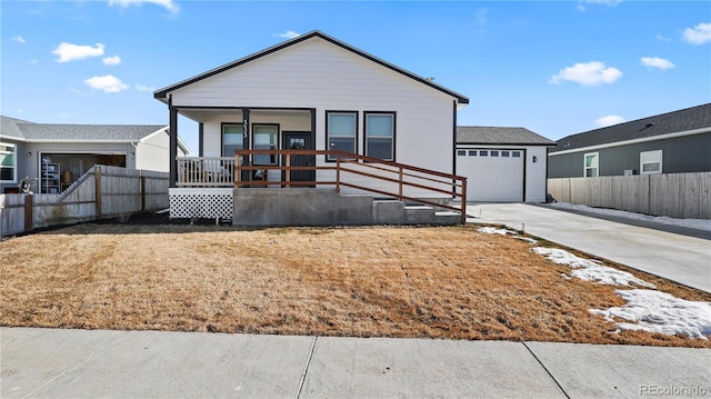 view of front of home featuring concrete driveway, a porch, an attached garage, and fence