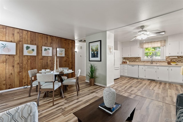 7310 Granada Rd, Denver, CO 80221 - living room featuring light wood-type flooring, a ceiling fan, and wooden walls
