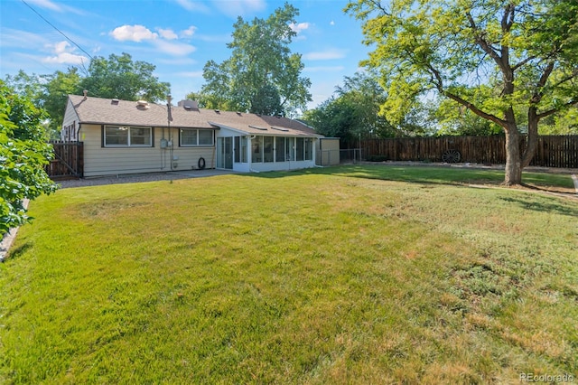7310 Granada Rd, Denver, CO 80221 - rear view of house featuring a fenced backyard and a sunroom