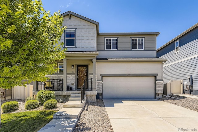 12851 Billingsley Trl, Parker, CO 80134 - view of front of home with a garage, concrete driveway, stone siding, and covered porch