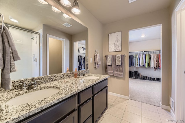 12851 Billingsley Trl, Parker, CO 80134 - full bathroom featuring a spacious closet, a stall shower, double vanity, and tile patterned floors