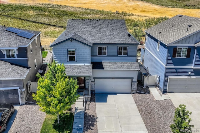 12851 Billingsley Trl, Parker, CO 80134 - view of front of property with stone siding, a garage, concrete driveway, a gate, and a shingled roof