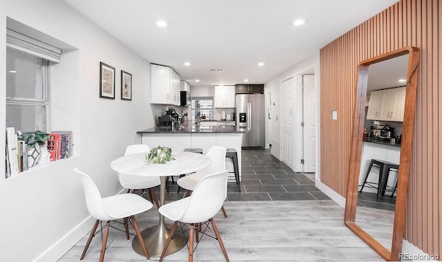 dining room with recessed lighting, baseboards, and wood finished floors