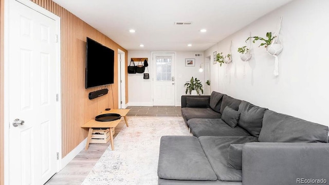 living room with recessed lighting, visible vents, and light wood-type flooring