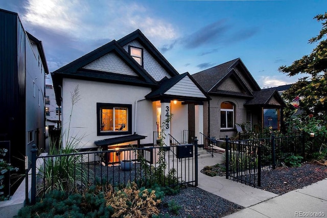 view of front facade with a fenced front yard and stucco siding