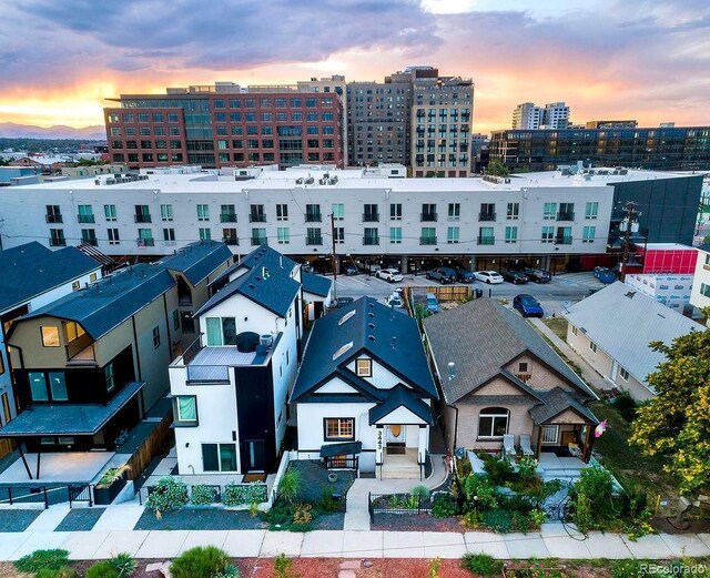 aerial view at dusk featuring a city view