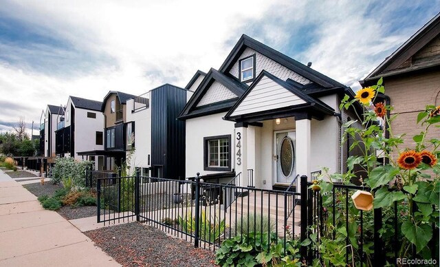 view of front of home with fence and stucco siding