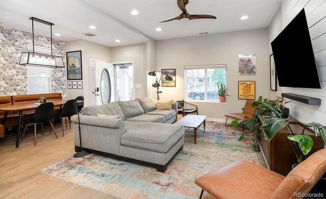 living area with a ceiling fan, visible vents, baseboards, recessed lighting, and light wood-style floors