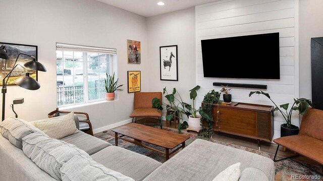 living room featuring recessed lighting, baseboards, and wood finished floors