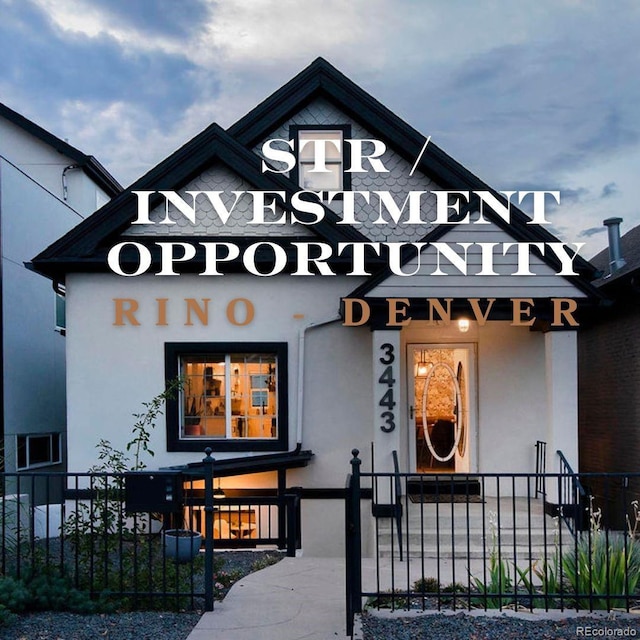 entrance to property with fence and stucco siding