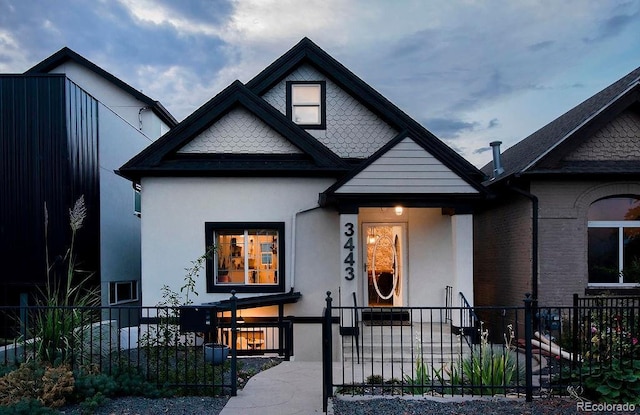 view of front of house featuring a fenced front yard and stucco siding