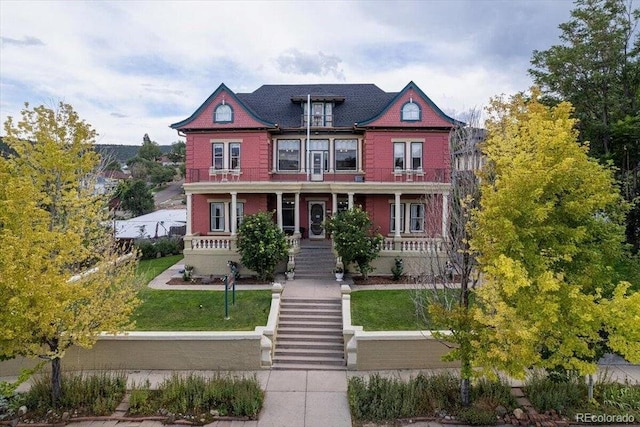 310 E 2nd St, Trinidad, CO 81082 - victorian-style house featuring covered porch, a front yard, and stairway