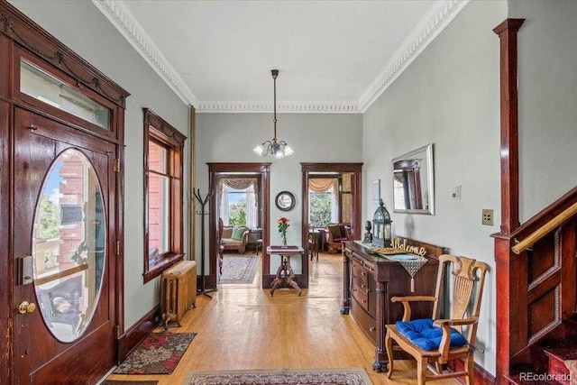 310 E 2nd St, Trinidad, CO 81082 - foyer with radiator heating unit, light wood-style floors, ornamental molding, and baseboards