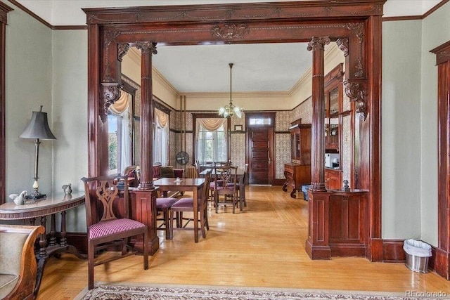 310 E 2nd St, Trinidad, CO 81082 - dining area featuring a chandelier, ornamental molding, light wood-style floors, and decorative columns