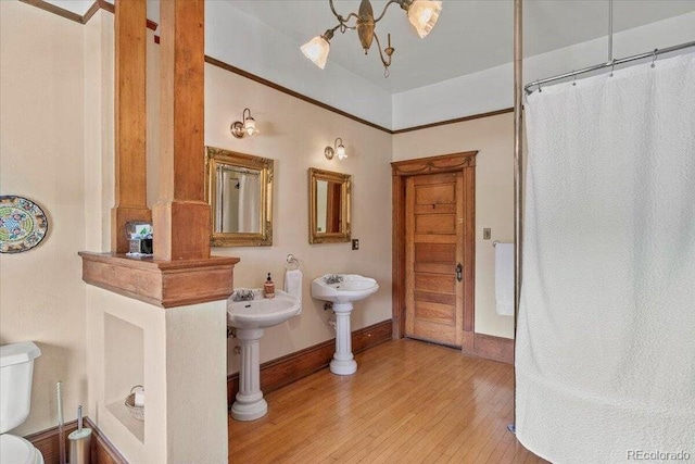 310 E 2nd St, Trinidad, CO 81082 - bathroom featuring wood finished floors, baseboards, a shower with curtain, and ornate columns