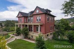 310 E 2nd St, Trinidad, CO 81082 - rear view of property with a lawn, a porch, and a balcony