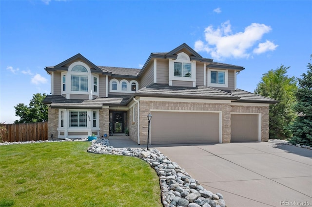 7056 S Owens St, Littleton, CO 80127 - view of front of home with concrete driveway, a garage, and brick siding