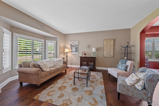 7056 S Owens St, Littleton, CO 80127 - living area with arched walkways, wood finished floors, plenty of natural light, and baseboards