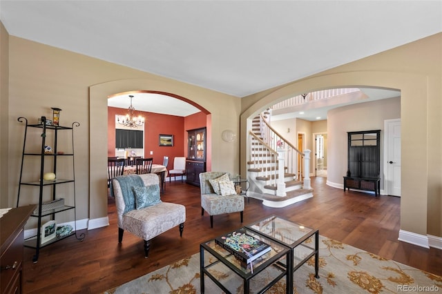 7056 S Owens St, Littleton, CO 80127 - living room with arched walkways, stairway, wood finished floors, and baseboards