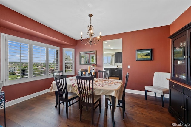 7056 S Owens St, Littleton, CO 80127 - dining space with a chandelier, dark wood-type flooring, baseboards, and plenty of natural light