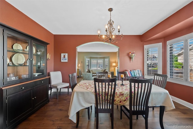 7056 S Owens St, Littleton, CO 80127 - dining space with a chandelier, arched walkways, dark wood finished floors, and baseboards