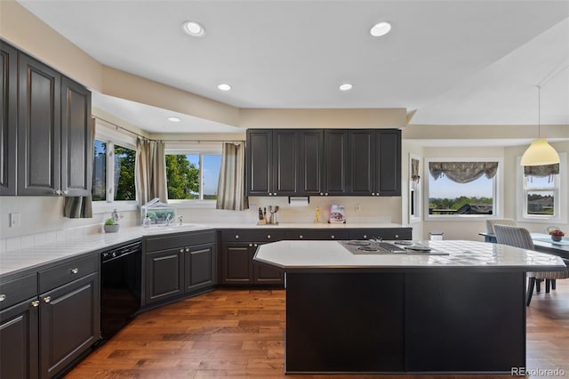 7056 S Owens St, Littleton, CO 80127 - kitchen with black dishwasher, stainless steel electric stovetop, light countertops, a sink, and a center island