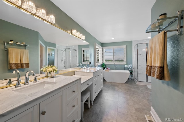 7056 S Owens St, Littleton, CO 80127 - bathroom with a stall shower, vanity, a freestanding tub, and tile patterned flooring