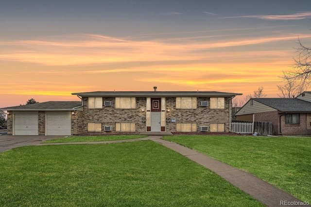 view of front facade with cooling unit, a yard, and a garage