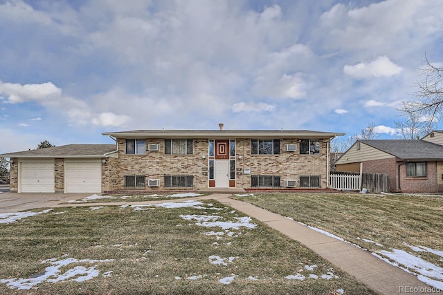 view of front of property featuring cooling unit, a garage, and a lawn