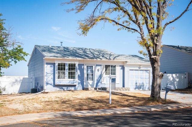 view of front facade featuring cooling unit and a garage