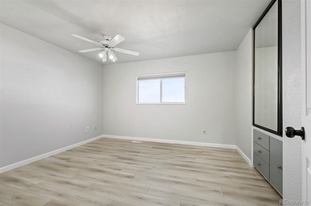 unfurnished bedroom with ceiling fan and light wood-type flooring