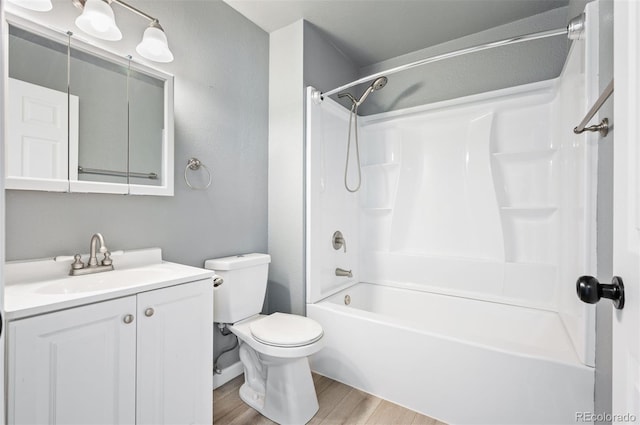 full bathroom featuring vanity, toilet, bathing tub / shower combination, and hardwood / wood-style floors