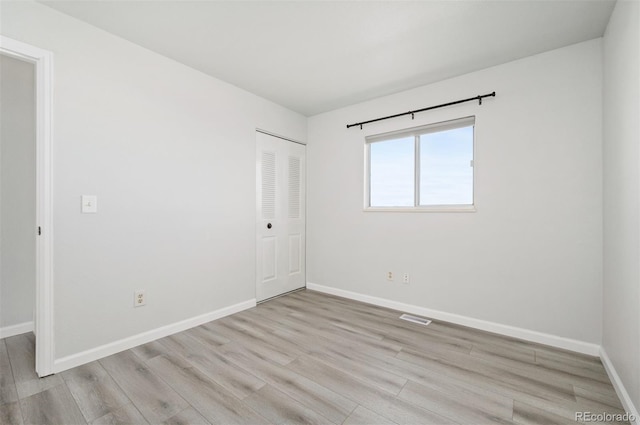 spare room featuring light wood-type flooring