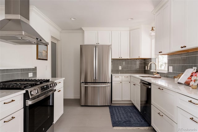 kitchen featuring wall chimney range hood, appliances with stainless steel finishes, a sink, light countertops, and tasteful backsplash