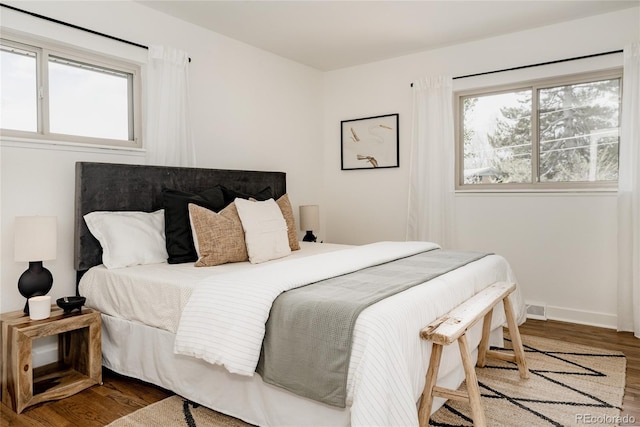 bedroom featuring baseboards and wood finished floors