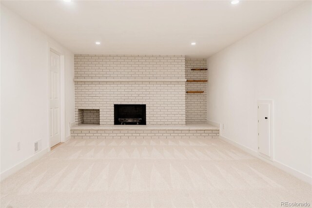 unfurnished living room with a fireplace, carpet, recessed lighting, baseboards, and visible vents