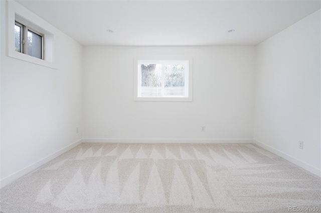 unfurnished room with carpet floors and baseboards