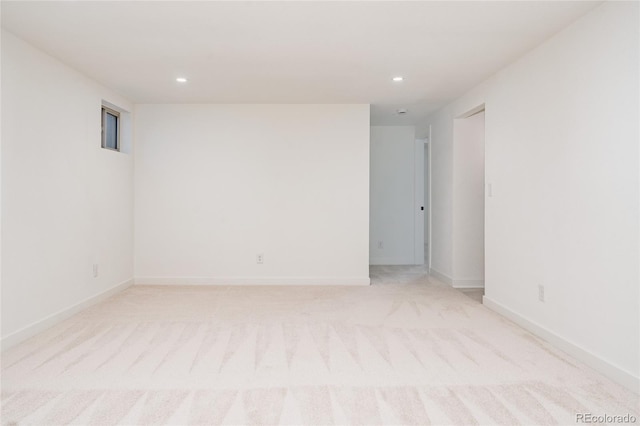 unfurnished room featuring recessed lighting, baseboards, and light colored carpet