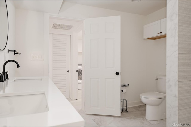 bathroom featuring toilet and a sink